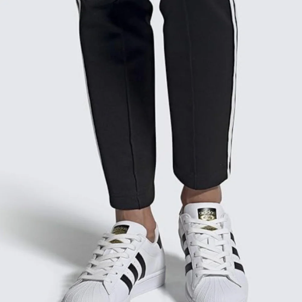 adidas Women’s White Sneakers with Black Stripes